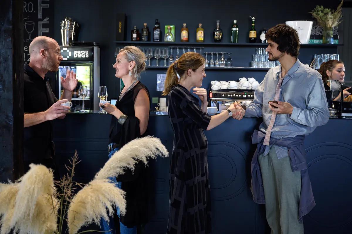 People talking at the bar of the EPIC café.